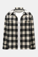 Ami Paris Overshirt black/cream checkered shown from the front, oversized fit, pure new wool lumberjack style with snap buttons, adjustable collar, patch chest pockets with flaps, classic sport cuffs, rounded hemline extended at the back, worn over a whit
