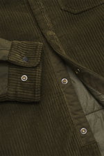 Close-up front view of the C.P. Company Corduroy Overshirt khaki, showcasing slim fit, corduroy cotton fabric, snap button placket, cuff sleeves, and patch pocket with lens detail. Casualwear with character: soft cotton quality, distinctive texture, funct