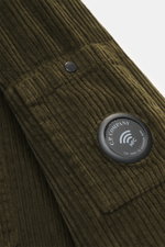 Close-up, angled view of the C.P. Company Corduroy Overshirt khaki showing the soft cotton corduroy texture, snap button, and label-typical lens detail on the upper arm pocket.