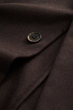 Close-up from above of a dark brown Barena Venezia Cashmere Overshirt button highlighting pure cashmere, very soft feel, Regular Fit, four-button placket, turn-down collar, patch chest and hip pockets, buttoned sleeve cuffs, unconstructed design, and two 