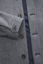 Nahaufnahme des Circolo 1901 Jersey-Overshirt grau gemustert von schräg oben, zeigt feines Webmuster, Knöpfe, Ärmel mit Knopf, Umlegekragen, softes Innenfutter, Slim Fit und aufgesetzte Hüfttaschen, ideal für stilvolle Layering-Looks im Herbst.