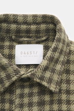 Nahaufnahme des Kragens und Labels des 04651/ A trip in a bag Overshirt 'Workwear Jacket' oliv/dark olive kariert, Baumwoll-Microfaser-Mix, weicher Griff, Karo-Webmuster.