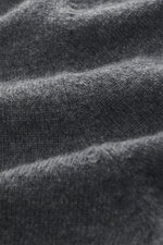 Nahaufnahme des feinen Strickbildes eines dunkelgrau melierten FTC Cashmere V-Neck Pullovers aus Fair-Trade-Cashmere mit weichem Griff.