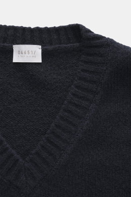 Close-up top-down view of the navy 04651/ A trip in a bag V-Neck Pullover 'Light Wool' featuring a mix of wool and microfiber, fine knit pattern, soft touch, regular fit, textured knit at hem and sleeves, and wide ribbed cuffs.