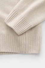 04651/ A trip in a bag Strickpolo 'Johnny' sand, Detailaufnahme von Arm und Bund, Merinowolle-Cashmere-Mix, Rippbündchen, feines Strickbild