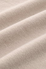 Close-up, angled view of beige terrycloth fabric texture of 04651/ A trip in a bag Terry hooded jumper 'Terry' beige.

Description: <p>Comfort and coolness with summery nonchalance: The hooded jumper 'Terry' by 04651/ A TRIP IN A BAG made of pure cotton t