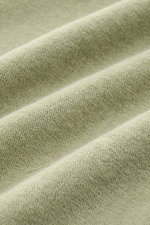 Close-up front view of the soft, sage terrycloth fabric of the 04651/ A trip in a bag Terry hooded jumper 'Terry' sage.

Description: <p>Comfort and coolness with summery nonchalance: The hooded jumper 'Terry' by 04651/ A TRIP IN A BAG made of pure cotton
