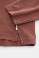 Close-up side view of 04651/ A trip in a bag Terry hooded jumper 'Terry' rust brown showing pure cotton terrycloth, soft feel, regular fit, practical hood, and small woven label in side seam.

<p>Comfort and coolness with summery nonchalance: The hooded j
