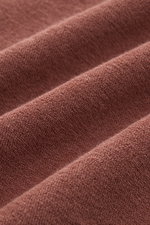 Close-up detail of rust brown terrycloth fabric showing texture and softness, photographed from a top angle, for 04651/ A trip in a bag Terry hooded jumper 'Terry' rust brown.

<p>Comfort and coolness with summery nonchalance: The hooded jumper 'Terry' by