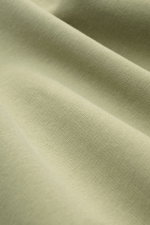 Nahaufnahme des gebürsteten Jersey-Stoffs in Salbeigrün, Detailansicht des Materials vom 04651/ A trip in a bag Kapuzenpullover 'IF Hoodie' salbei.