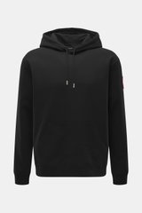 Front view of Canada Goose Hoodie 'Loon' black with hood, drawstring, kangaroo pocket, ribbed cuffs, and logo on upper arm.

Description: <p>Urban style meets comfort – the 'Loon' hoodie by CANADA GOOSE combines pleasant wearing comfort with a sporty-eleg