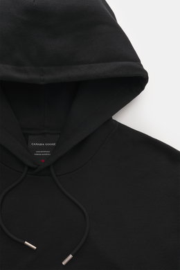 Close-up front view of the Canada Goose Hoodie 'Loon' black, showing hood with drawstring and label inside collar.

<p>Urban style meets comfort – the 'Loon' hoodie by CANADA GOOSE combines pleasant wearing comfort with a sporty-elegant design.</p>
<ul>
<