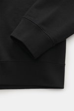 Black fabric close-up showing the ribbed cuff and hem of the Canada Goose Hoodie 'Loon' black, photographed from a side angle. Urban style meets comfort – the 'Loon' hoodie by CANADA GOOSE combines pleasant wearing comfort with a sporty-elegant design.
- 