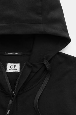 Nahaufnahme der Kapuze der C.P. Company Sweatjacke schwarz aus elastischem Baumwoll-Stretch-Fleece, mit Tunnelzug und robustem Reißverschluss.