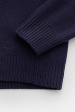 Close-up front view of the cuff and hem of the 04651/ A trip in a bag Hooded jumper dark blue, showing medium-fine knit and wide ribbed bands. <p>Provides reliable warmth: This hooded jumper from 04651/ A TRIP IN A BAG, with its turtleneck and hood design