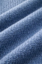 Close-up front view of the 04651/ A trip in a bag Cashmere Rollkragenpullover rauchblau showing soft, coarse knit texture in pure cashmere with oversized fit, turtleneck, and ribbed cuffs, perfect for cool days.