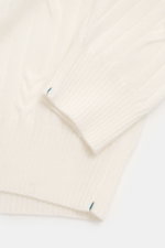 Fioroni Cashmere Turtleneck Sweater Cream shown from above, highlighting pure cashmere, soft touch, cable knit, slim fit, turtleneck, and ribbed cuffs.