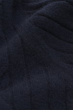 Close-up front view of Fioroni Cashmere turtleneck sweater navy showing cable knit pattern, fine texture, and ribbed cuffs.