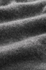 Close-up, macro perspective of the fine knit pattern and soft texture of the Fioroni Cashmere Turtleneck Sweater 'Duvet' dark grey mélange, showcasing pure cashmere fibers and luxurious warmth with a very soft feel, ribbed turtleneck, and flexible ribbed 