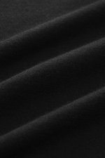 Close-up front view of the fine knit black fabric of the Fioroni Cashmere turtleneck sweater 'Duvet' black, showing pure cashmere texture.
