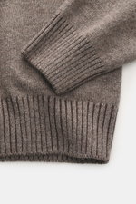 Close-up top view of the Gran Sasso Cashmere turtleneck sweater taupe melange showing medium-fine knit pattern, pure cashmere, very soft feel, regular fit, fitted turtleneck, and comfortable ribbed cuffs.