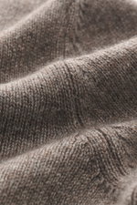 Gran Sasso Cashmere turtleneck sweater taupe melange shown in close-up from a side angle, highlighting pure cashmere, very soft feel, medium-fine knit pattern, regular fit, fitted turtleneck, and comfortable ribbed cuffs.