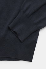 Gran Sasso Fine knit turtleneck sweater navy shown from a close-up top-down view, featuring a mix of virgin wool, cashmere, and silk, soft touch, very fine knit pattern, regular fit, fitted turtleneck, and fine elastic ribbed cuffs.