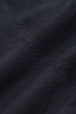 Close-up image from a top angle showing the navy fabric of the Gran Sasso Fine knit turtleneck sweater navy, featuring a mix of virgin wool, cashmere, and silk, soft touch, very fine knit pattern, regular fit, fitted turtleneck, and fine, elastic ribbed c
