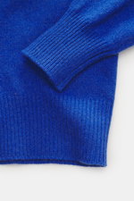 Close-up, top-down view of the B.F. Knitwear Cashmere Turtleneck Sweater blue showing its soft pure cashmere fabric with a medium-fine knit pattern, fitted turtleneck, elastic rib-knit cuffs, and slim fit, perfect for autumn, made in Italy.