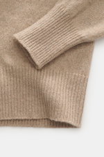 Close-up top-down view of B.F. Knitwear Cashmere Turtleneck Sweater beige sleeve and body showing soft pure cashmere, medium-fine knit, slim fit, elastic rib-knit cuffs, and fitted turtleneck. Autumnal cashmere by the knitting expert B.F. KNITWEAR: This s