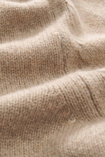 Close-up front view of B.F. Knitwear Cashmere Turtleneck Sweater beige showing soft pure cashmere, medium-fine knit, and rib-knit cuffs.