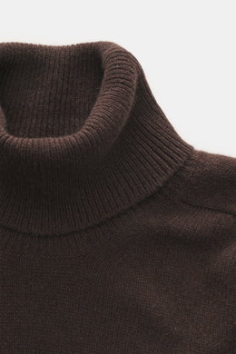 Close-up top-down view of B.F. Knitwear Cashmere Turtleneck Sweater dark brown showing fitted turtleneck, soft medium-fine knit, and rib-knit cuffs.
