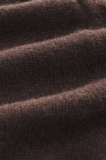Close-up front view of B.F. Knitwear Cashmere Turtleneck Sweater dark brown showing soft pure cashmere knit with medium-fine pattern, slim fit, fitted turtleneck, and elastic rib-knit cuffs, perfect for autumn, made in Italy.