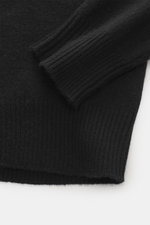 B.F. Knitwear Cashmere Turtleneck Sweater Black shown from a close-up top angle, featuring elastic rib-knit cuffs, slim fit, soft pure cashmere.