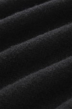 Close-up, angled view of B.F. Knitwear Cashmere Turtleneck Sweater Black showing pure cashmere's soft touch and medium-fine knit pattern.