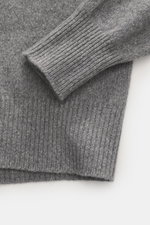 Close-up top view of B.F. Knitwear Cashmere Turtleneck Sweater grey melange showing soft medium-fine knit, fitted turtleneck, and elastic rib-knit cuffs.

Additional description: 
<p>Autumnal cashmere by the knitting expert B.F. KNITWEAR: This softly knit