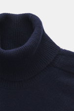 Close-up top-down view of B.F. Knitwear Cashmere Turtleneck Sweater navy, a pure cashmere, soft-touch, slim fit turtleneck with medium-fine knit and elastic cuffs.