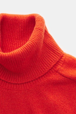 Close-up front view of B.F. Knitwear Cashmere Turtleneck Sweater orange showing fitted turtleneck, medium-fine knit, and rib-knit cuffs.