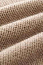 Close-up front view of B.F. Knitwear Cashmere turtleneck sweater beige melange showing coarse knit texture and soft pure cashmere fibers.