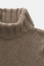 Close-up front view of B.F. Knitwear Cashmere turtleneck sweater taupe melange showing coarse knit texture and fitted turtleneck.