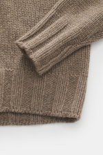 Close-up front view of B.F. Knitwear Cashmere turtleneck sweater taupe melange showing coarse knit texture, ribbed cuffs, and regular fit.