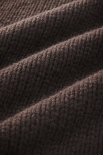 Close-up front view of the coarse knit texture of the B.F. Knitwear Cashmere turtleneck sweater dark brown in pure cashmere.
