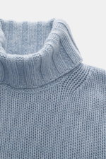 Close-up front view of B.F. Knitwear Cashmere turtleneck sweater light blue melange, showing coarse knit, fitted collar, and soft texture.