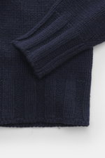 Close-up top-down view of the B.F. Knitwear Cashmere turtleneck sweater navy showing coarse knit texture, fitted turtleneck, elastic ribbed cuffs, pure cashmere, soft touch, and regular fit, perfect for autumnal wear made in Italy.