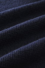 Close-up front view of B.F. Knitwear Cashmere turtleneck sweater navy showing coarse knit texture and soft touch fabric.
