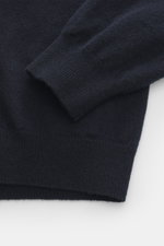 Close-up view of Aida Barni Cashmere turtleneck sweater navy sleeve and cuff, showing pure cashmere, soft feel, fine knit, slim fit, close-fitting turtleneck, and ribbed cuffs. Italian knitwear by AIDA BARNI: With a timeless look and finest cashmere, this