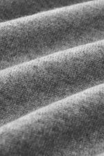 Close-up front view of the Aida Barni Cashmere turtleneck sweater grey melange showing pure cashmere, soft feel, fine knit pattern, slim fit, close-fitting turtleneck, and flexible ribbed cuffs, Italian knitwear perfect for autumn/winter.
