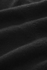 Close-up front view of Aida Barni Cashmere turtleneck sweater black showing fine knit pattern and soft pure cashmere texture.