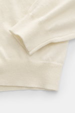 Close-up front view of Aida Barni Cashmere turtleneck sweater cream showing the fine knit pattern, flexible ribbed cuffs, and soft pure cashmere fabric.