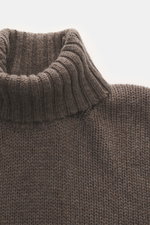 Nahaufnahme aus Frontperspektive des Della Ciana Rollkragenpullovers graubraun meliert mit Rollkragen, mittelgrobem Strickbild, Slim Fit, weichem Griff, Mix aus Wolle und Cashmere und komfortablen Rippbündchen.